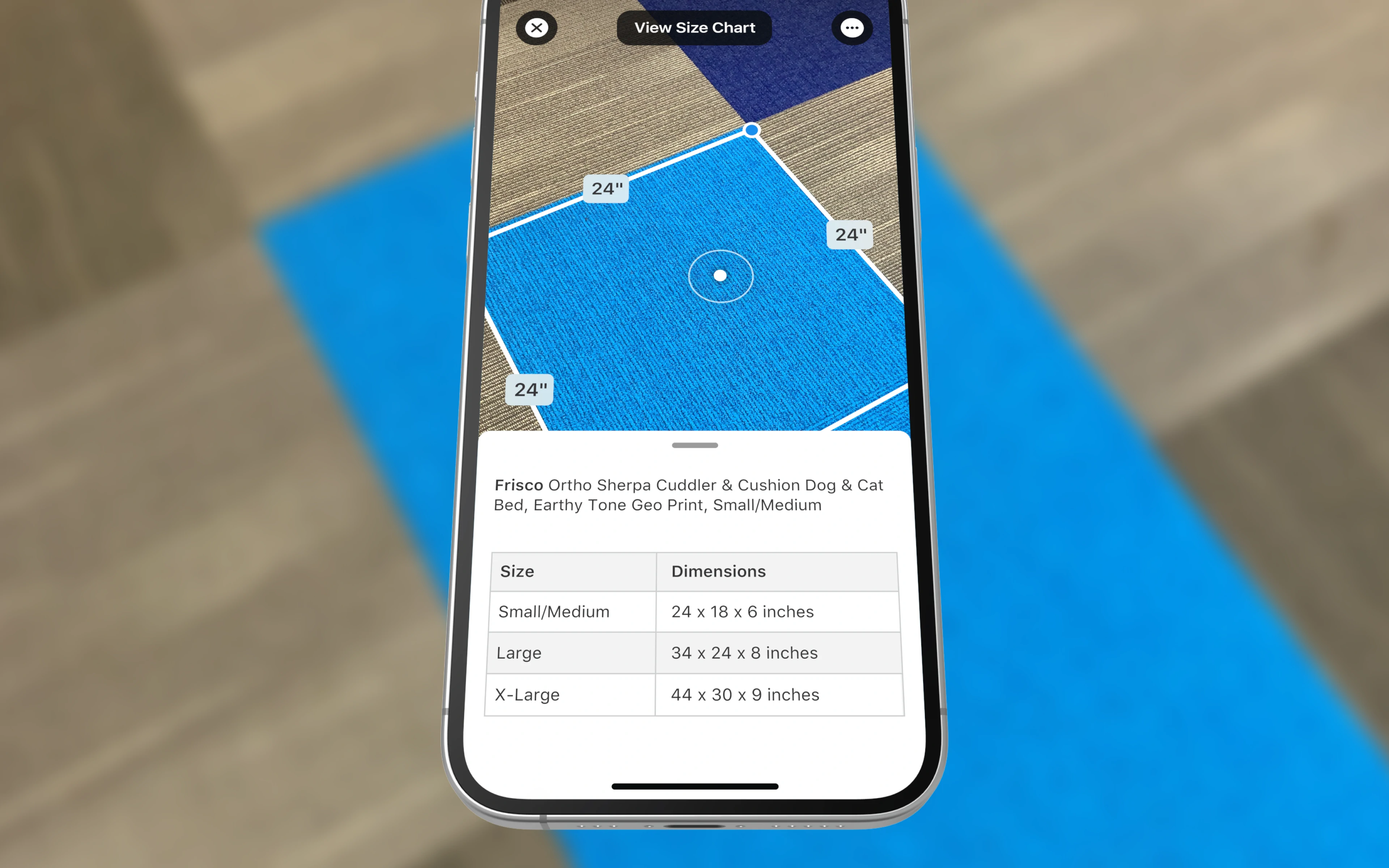 A phone screen displaying measurements of a blue carpet, with a size chart for a dog bed shown below.